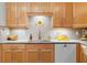 Bright kitchen featuring light wood cabinets, stainless steel appliances, a tile backsplash, and modern countertops at 2779 Bentley Se Pl, Marietta, GA 30067