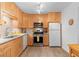 Well-lit kitchen with stainless steel appliances, wooden cabinets, and hardwood floors at 2779 Bentley Se Pl, Marietta, GA 30067