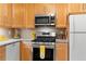 Charming kitchen features stainless steel appliances, gas range, wood cabinets and stone countertops at 2779 Bentley Se Pl, Marietta, GA 30067