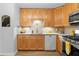 Well-lit kitchen featuring light wood cabinets, stainless steel appliances, and tile backsplash at 2779 Bentley Se Pl, Marietta, GA 30067