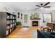 Cozy living room with hardwood floors, fireplace, ceiling fan, and built-in bookshelf at 2779 Bentley Se Pl, Marietta, GA 30067