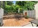 Outdoor patio with a dining set surrounded by lush greenery and a privacy fence at 2779 Bentley Se Pl, Marietta, GA 30067
