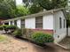 Side view of home featuring brick accents, white siding, and well-maintained landscaping at 2800 Browntown Nw Rd, Atlanta, GA 30318