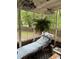 Relaxing screened-in porch with a lounger, plants, and a view of the yard at 2800 Browntown Nw Rd, Atlanta, GA 30318