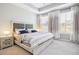 Comfortable bedroom featuring neutral colors, tray ceiling, and lots of natural light at 3313 Park Pointe Cir, Scottdale, GA 30079