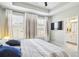 Bedroom features a TV, tray ceiling, and a convenient ensuite bathroom at 3313 Park Pointe Cir, Scottdale, GA 30079