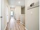Light-filled hallway with wood floors and an elegant art piece at 3313 Park Pointe Cir, Scottdale, GA 30079