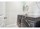 Functional laundry room with modern washer and dryer units and storage shelf at 3313 Park Pointe Cir, Scottdale, GA 30079
