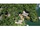 The aerial view shows a waterfront property with private boat docks and a lush, wooded landscape at 7815 Bamby Rd, Cumming, GA 30041