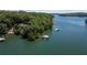Aerial view featuring a waterfront property with private boat dock and covered boat slip on the lake at 7815 Bamby Rd, Cumming, GA 30041
