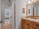 Bathroom vanity with granite counters, wood cabinets, and tan tile floors at 7815 Bamby Rd, Cumming, GA 30041
