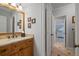 Well-lit bathroom featuring a wooden vanity with granite countertops and decorative wall art at 7815 Bamby Rd, Cumming, GA 30041