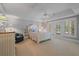 Spacious bedroom with a tray ceiling, carpet, ceiling fan, and access to a balcony at 7815 Bamby Rd, Cumming, GA 30041