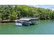 Dock with a covered boat slip provides storage and protection for your watercraft at 7815 Bamby Rd, Cumming, GA 30041