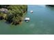 View of lake featuring a covered boat dock with a boat lift and small sailboat at 7815 Bamby Rd, Cumming, GA 30041
