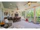 Relaxing covered porch features ceiling fans, comfortable seating, and picturesque outdoor views at 7815 Bamby Rd, Cumming, GA 30041
