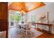 Dining room featuring a wood ceiling, hardwood floors, chandelier, and large window with wooded views at 7815 Bamby Rd, Cumming, GA 30041