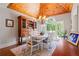 Light-filled dining room featuring a wood ceiling, hardwood floors, and a large window with wooded views at 7815 Bamby Rd, Cumming, GA 30041