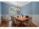 Elegant dining room features a wooden table and chairs with patterned upholstery and a decorative chandelier at 7815 Bamby Rd, Cumming, GA 30041