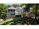 Beautiful home boasting dual screened porches, stone detailing, and a built-in hot tub for ultimate relaxation at 7815 Bamby Rd, Cumming, GA 30041