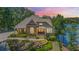 Charming home on the lake with stone and siding exterior, complemented by lush landscaping and serene water views at 7815 Bamby Rd, Cumming, GA 30041