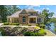 Charming exterior elevation of a stone and siding home with manicured landscaping and lake views at 7815 Bamby Rd, Cumming, GA 30041