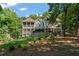Elegant lakefront home with expansive porches offers luxurious living and beautiful outdoor spaces for relaxation and entertaining at 7815 Bamby Rd, Cumming, GA 30041