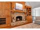 Living room with stone fireplace, built-in cabinets, and a cozy seating area at 7815 Bamby Rd, Cumming, GA 30041