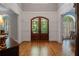 Spacious foyer with hardwood floors, arched doorway, and elegant trim at 7815 Bamby Rd, Cumming, GA 30041