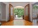 Open foyer with hardwood floors, arched doorway, and views of outdoor space at 7815 Bamby Rd, Cumming, GA 30041