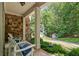 Inviting front porch with stone accents and comfortable seating at 7815 Bamby Rd, Cumming, GA 30041