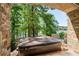 This hot tub is located on a patio, with views of the lake and a cozy stone surround at 7815 Bamby Rd, Cumming, GA 30041