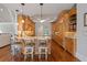Charming eat-in kitchen with an island, granite countertops, hardwood flooring, and pendant lighting at 7815 Bamby Rd, Cumming, GA 30041