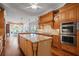 Spacious kitchen featuring an island, granite countertops, and wood cabinets with stainless steel appliances at 7815 Bamby Rd, Cumming, GA 30041