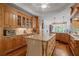 Open kitchen with custom wood cabinets, granite countertops, hardwood flooring, and stainless appliances at 7815 Bamby Rd, Cumming, GA 30041
