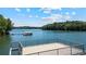 Balcony view overlooking the lake with a covered boat dock and boat slip at 7815 Bamby Rd, Cumming, GA 30041