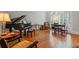 Cozy music room with a piano, a desk and elegant hardwood floors, perfect for relaxation and entertainment at 7815 Bamby Rd, Cumming, GA 30041