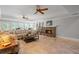 Relaxing living room features a stone fireplace, ceiling fans, and French doors at 7815 Bamby Rd, Cumming, GA 30041