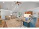 Bright living room with vaulted ceilings, hardwood floors, a view of a partial kitchen, and lots of seating at 7815 Bamby Rd, Cumming, GA 30041