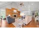 Bright living room with vaulted ceilings, a stone fireplace, hardwood floors, and lots of natural light at 7815 Bamby Rd, Cumming, GA 30041