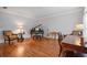 Cozy music room with a piano, a desk and elegant hardwood floors, perfect for relaxation and entertainment at 7815 Bamby Rd, Cumming, GA 30041