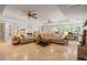 Spacious living room with a large sofa, tile floor, and lots of natural light at 7815 Bamby Rd, Cumming, GA 30041