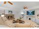 Inviting living room features a stone fireplace, ceiling fans, and comfortable seating at 7815 Bamby Rd, Cumming, GA 30041