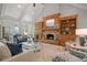 Bright living room with vaulted ceilings, a stone fireplace, hardwood floors, and lots of natural light at 7815 Bamby Rd, Cumming, GA 30041