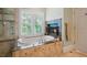 Luxurious main bathroom featuring a soaking tub, walk-in shower, and a cozy fireplace at 7815 Bamby Rd, Cumming, GA 30041