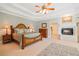 Spacious main bedroom boasts a fireplace, tray ceilings, and a luxurious, comfortable ambiance at 7815 Bamby Rd, Cumming, GA 30041