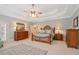Elegantly furnished main bedroom featuring a decorative rug, tray ceiling, and ample natural light at 7815 Bamby Rd, Cumming, GA 30041