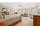 Inviting main bedroom with fireplace, seating area, and large windows offering serene views at 7815 Bamby Rd, Cumming, GA 30041