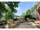 Stone patio featuring wicker furniture with a view of the lake and backyard at 7815 Bamby Rd, Cumming, GA 30041