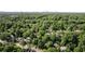 Aerial view of a neighborhood filled with lush trees, showcasing the city skyline in the distance at 820 Highland Ne Ter, Atlanta, GA 30306